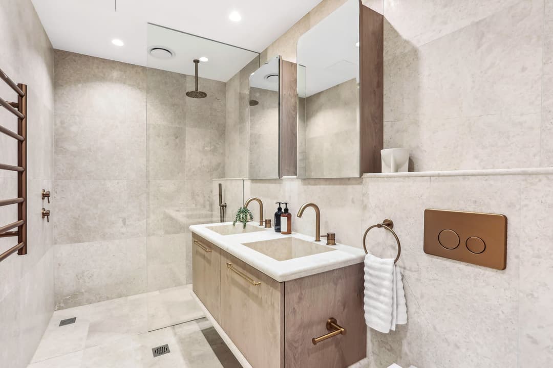 Contemporary ensuite with timber vanity and brass fixtures